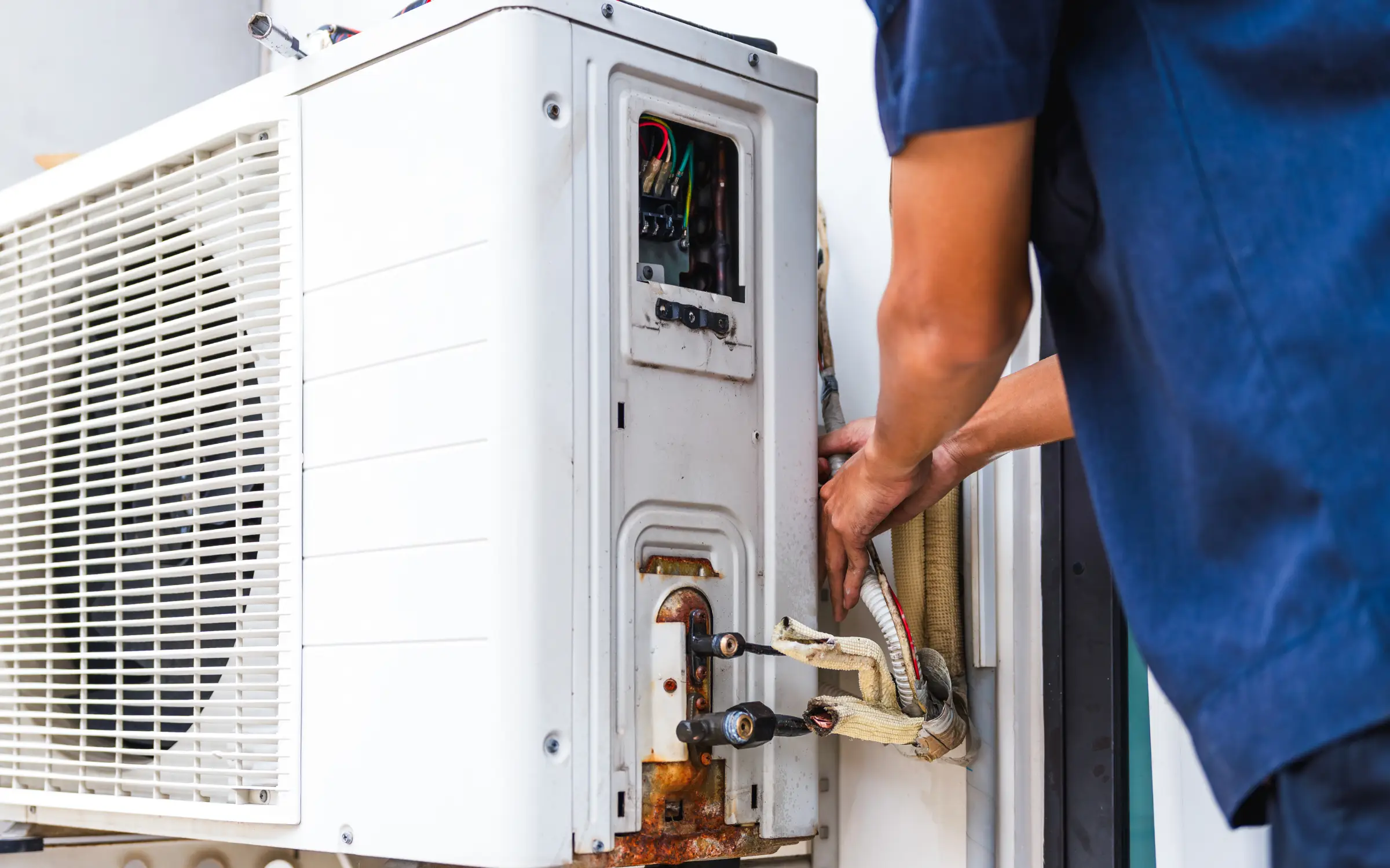 A man repairing an HVAC leak