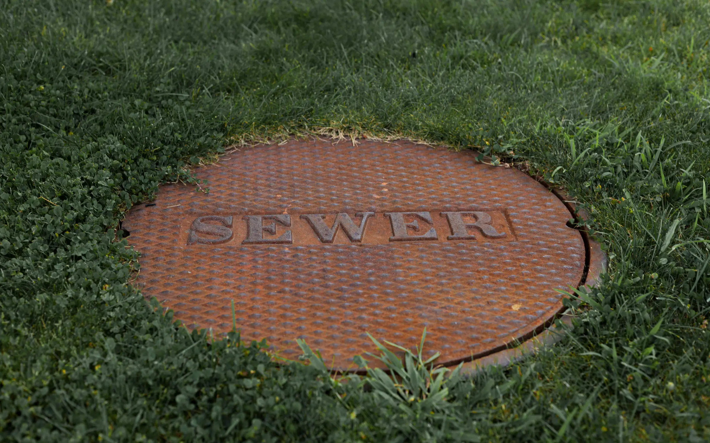 A sewer manhole cover, representing sewage backup in Maryland causing water damage