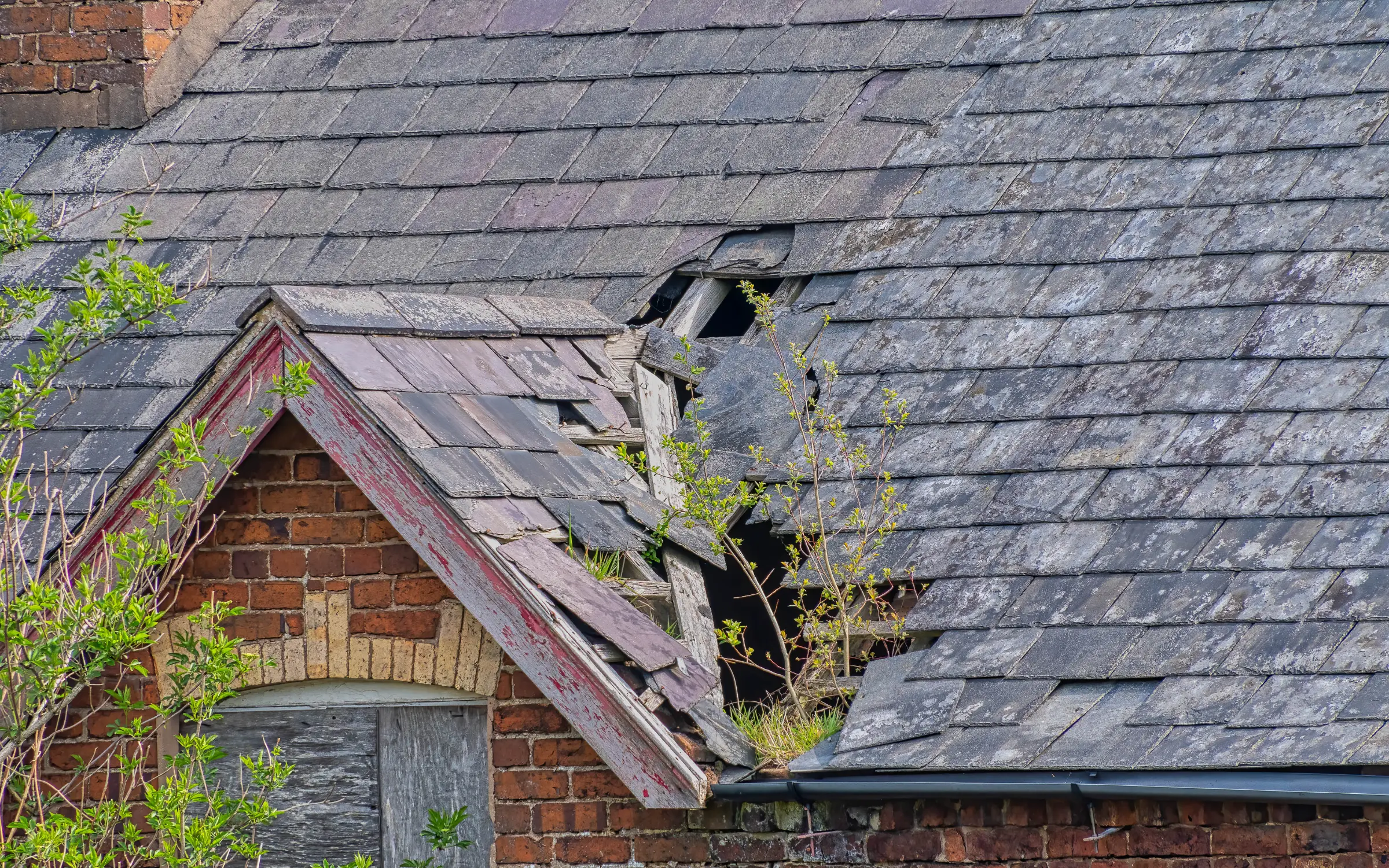 A storm damaged roof in Maryland, representing the need for storm damage board up services