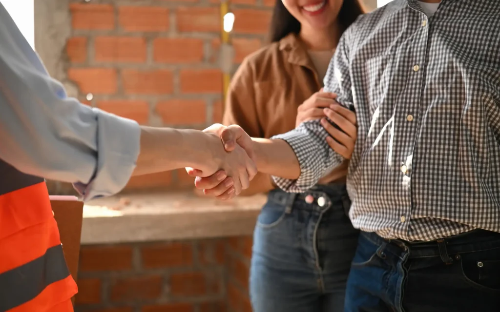 A Reyes Restoration contractor shaking the hand of a homeowner, representing trusted storm damage repair contractors in Maryland